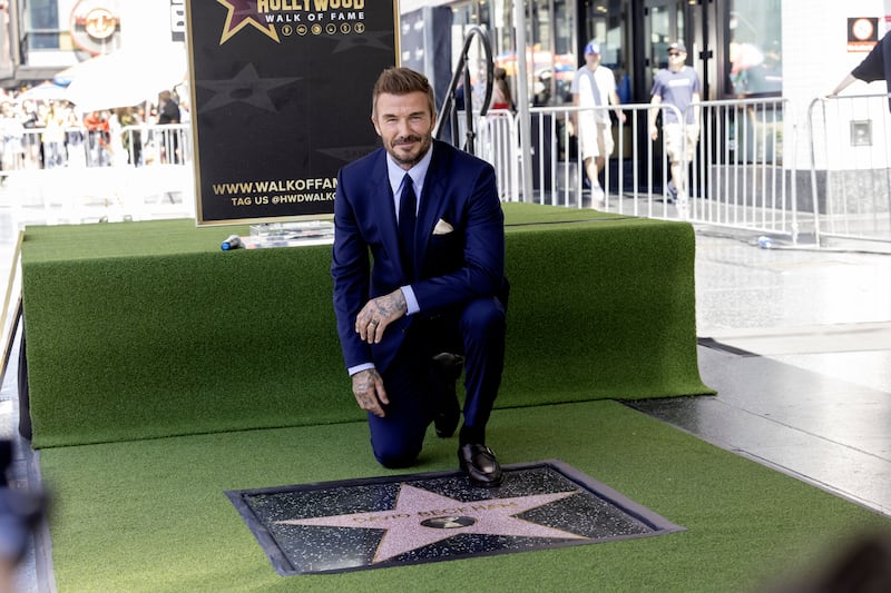 David Beckham poses next to his star during a ceremony honouring him on the Hollywood Walk of Fame in Los Angeles last week. Photograph:  Ted Soqui/EPA