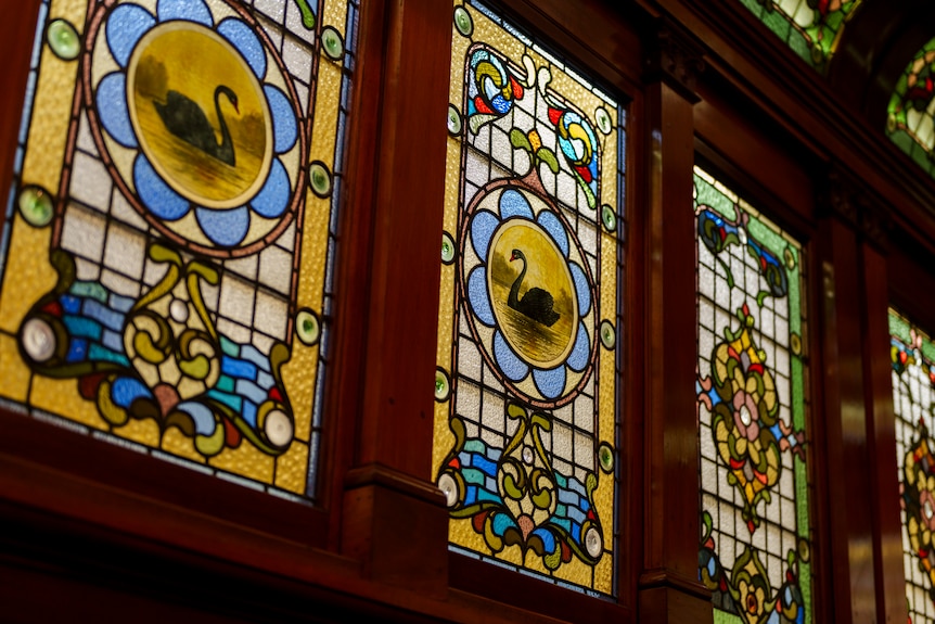 Stained glass windows showing a black swan adorn the walls of parliament