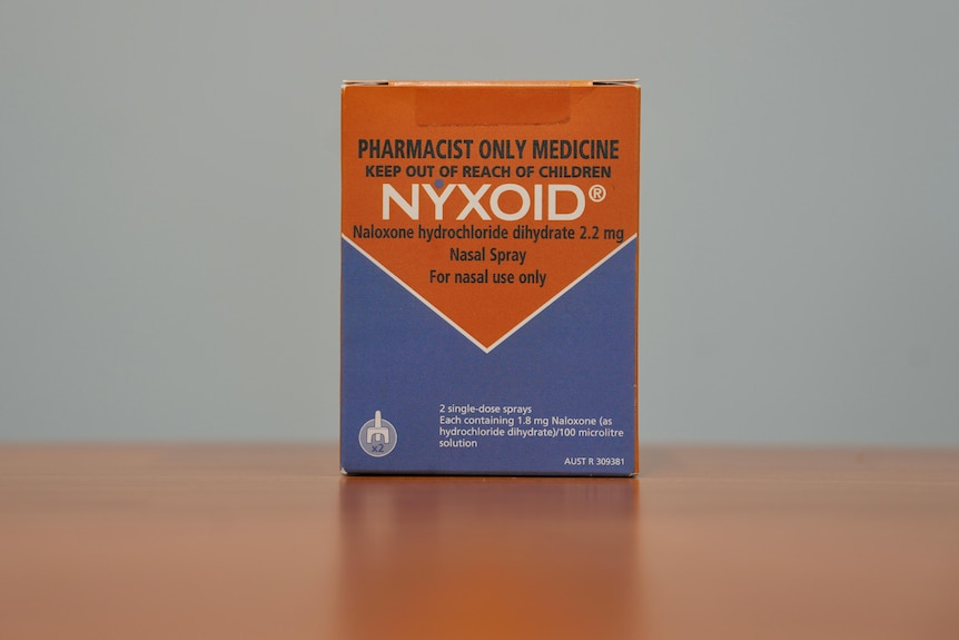 An orange and blue box of Nyxoid nasal spray.