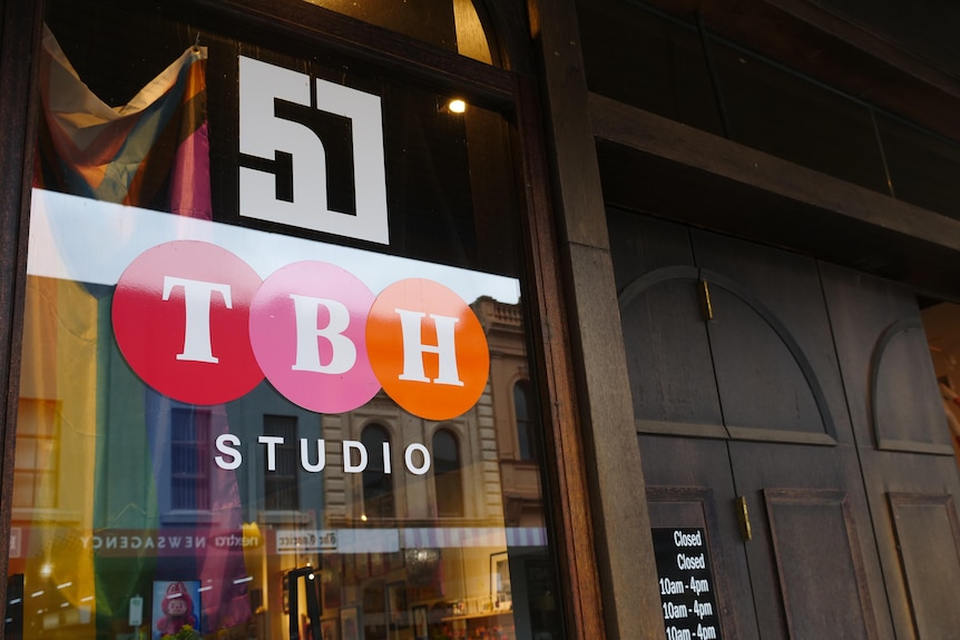 The studio logo TBH on a window.