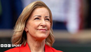Close up of Chris Evert wearing a red jacket and staring slightly up to the sky