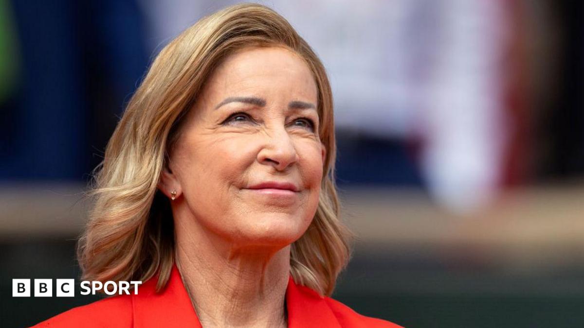 Close up of Chris Evert wearing a red jacket and staring slightly up to the sky