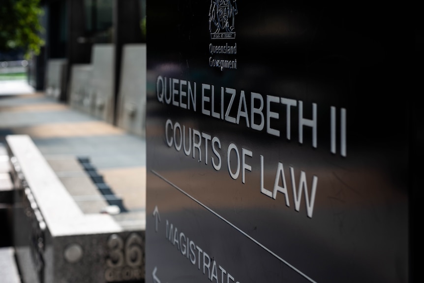 Signs and markers pointing to Brisbane's Magistrates Court