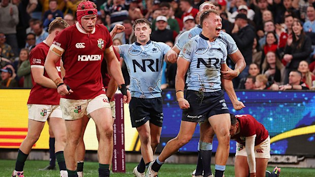 Darby Lancaster of the Waratahs celebrates scoring a try.