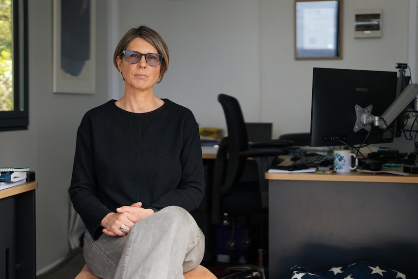 Woman poses for photo in an office
