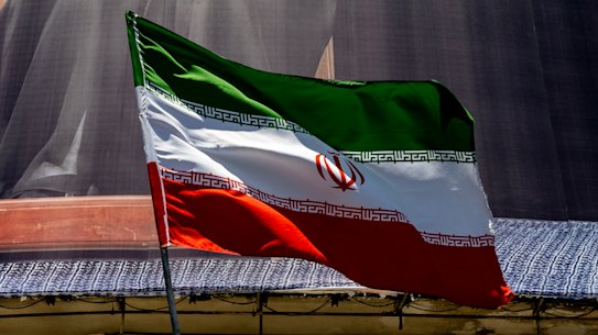 An Iranian flag is waved in Tehran.