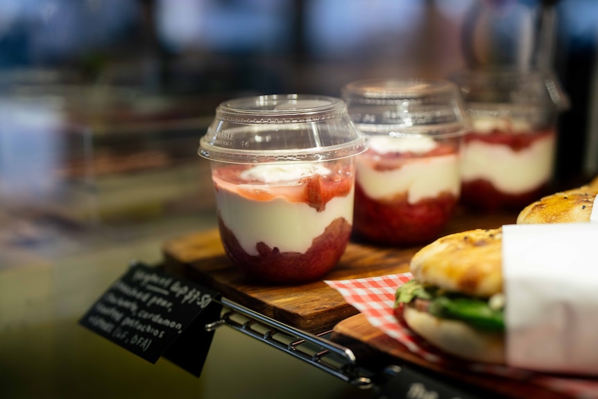 Yogurt cups on a shelf in a cafe