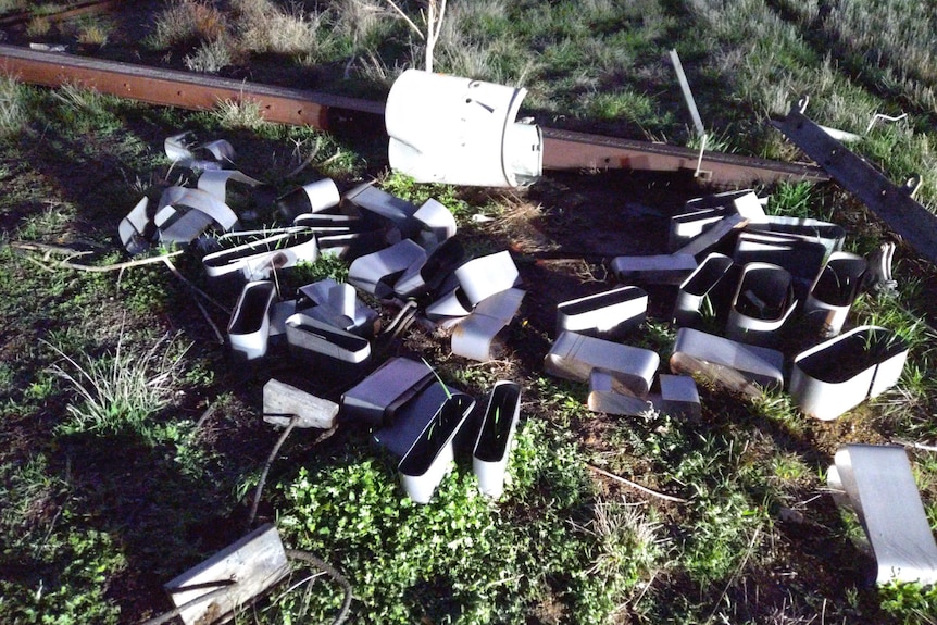 A transformer from stripped down Sobie pole is in pieces on the ground
