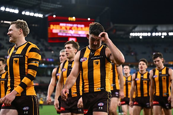 James Sicily and Jai Newcombe lead the Hawks off the ground after their loss to the Bulldogs.