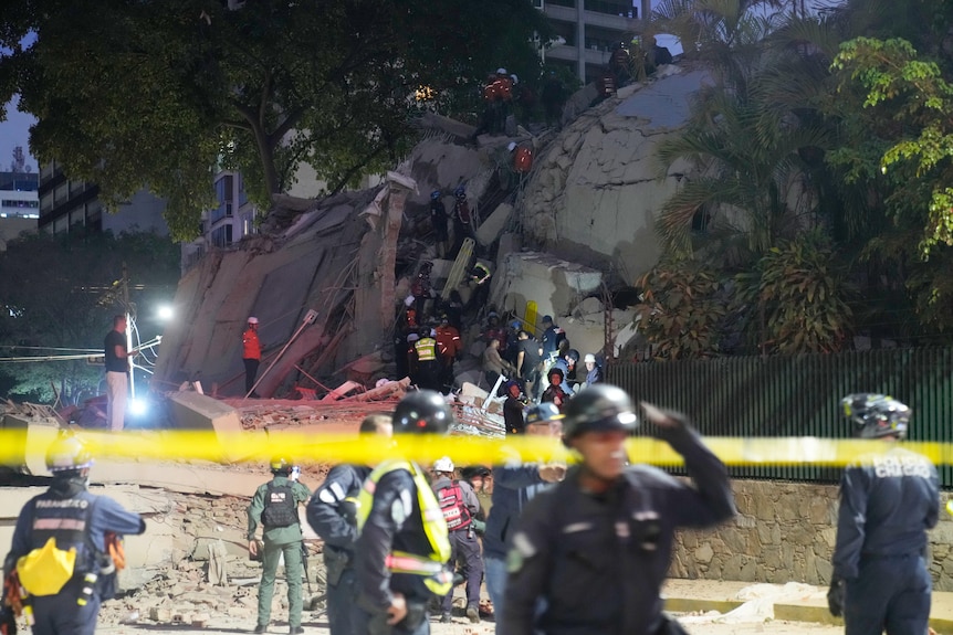 rubble and a collapsed building visited by emergency services