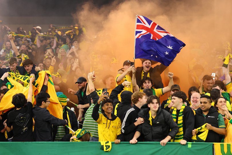 Socceroos supporters celebrate a goal.