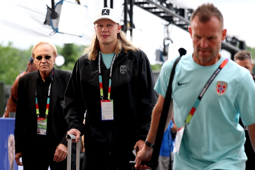 Norway striker Erling Haaland is in casual clothes and a cap arriving for a game