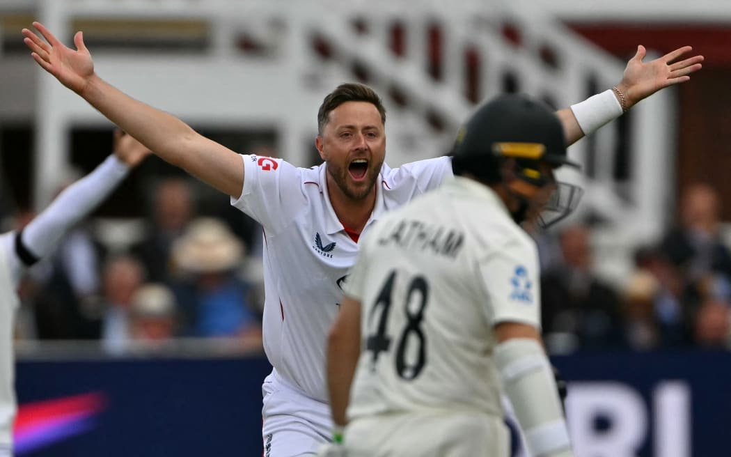 England's Ollie Robinson celebrates taking the wicket of New Zealand's Devon Conway on the opening day of the first cricket test match between England and New Zealand at Lord's cricket ground in London on June 4, 2026. (Photo by Glyn KIRK / AFP) / RESTRICTED TO EDITORIAL USE. NO ASSOCIATION WITH DIRECT COMPETITOR OF SPONSOR, PARTNER, OR SUPPLIER OF THE ECB