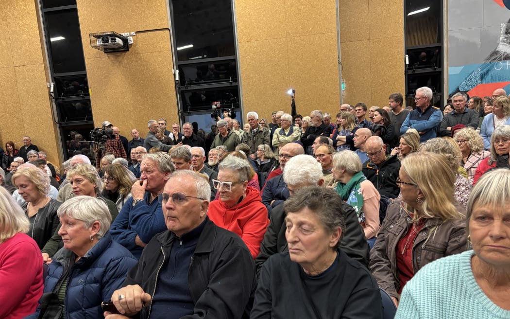 A packed public meeting at the Pegasus Bay School opposing the purchase of Pegasus' 18 hole championship golf course by housing developer Wolfbrook.