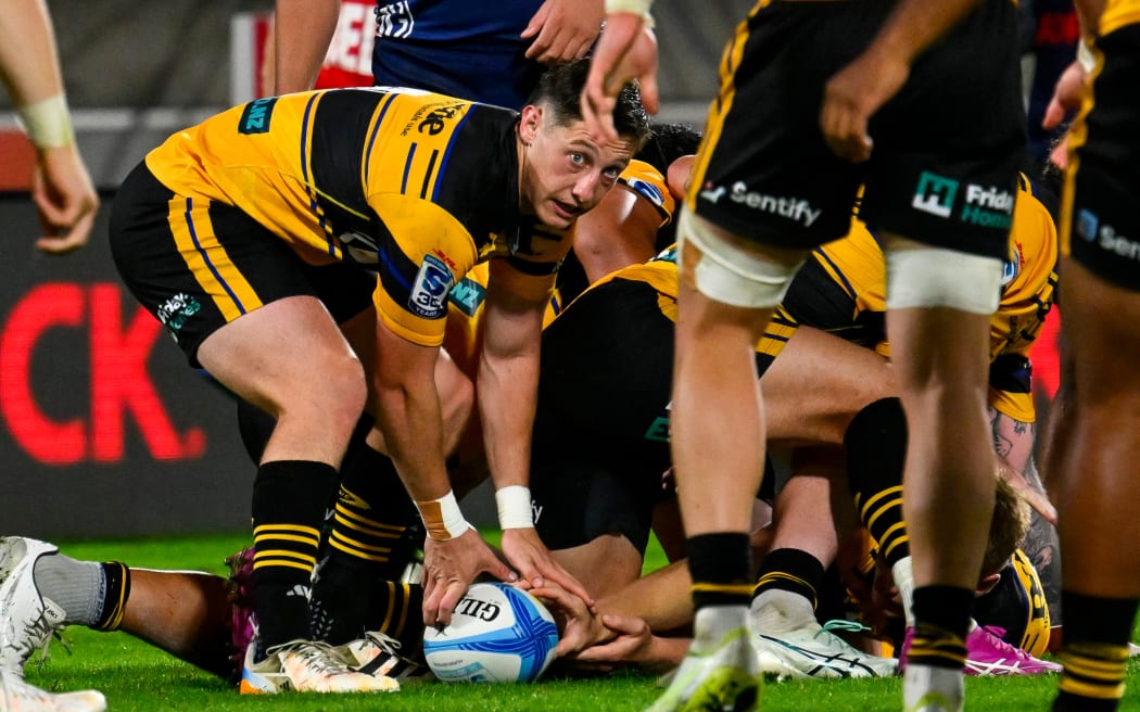 Cam Roigard of the Hurricanes looks to pass from a ruck.