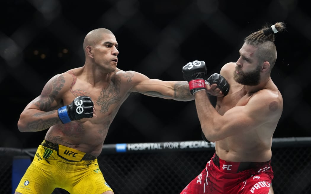 Brazil's Alex Pereira, left, punches Czech Republic's Jiri Prochazka during the second round of a light heavyweight title bout at the UFC 295.