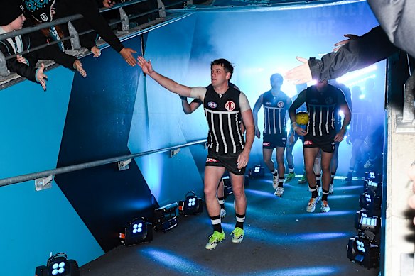 Zak Butters of the Power leads his team out.