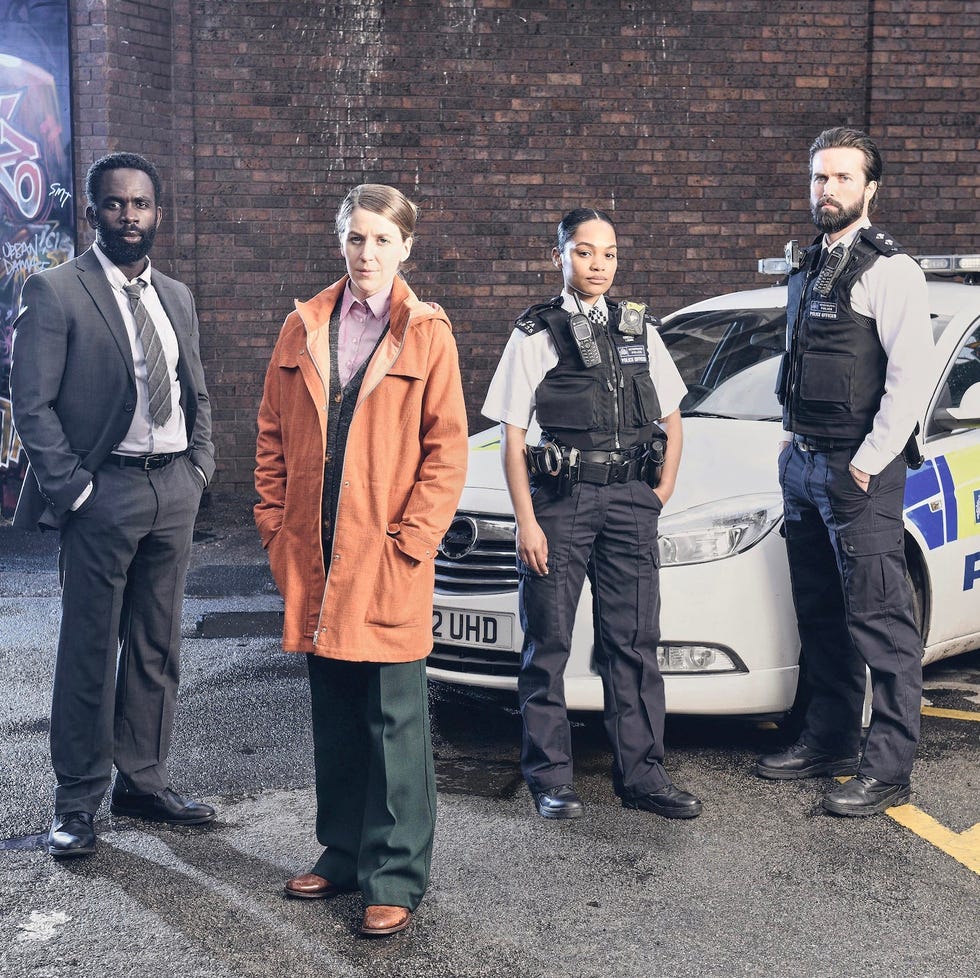 group of individuals in front of a police car near a graffiti wall group of individuals in front of a police car near a graffiti wall