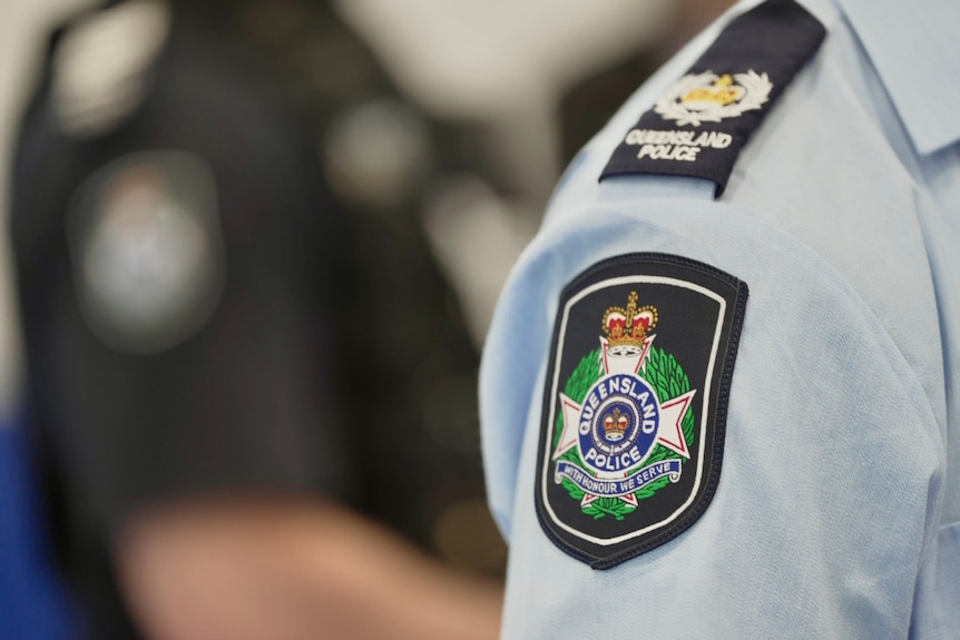 A Queensland police badge on a sleeve.