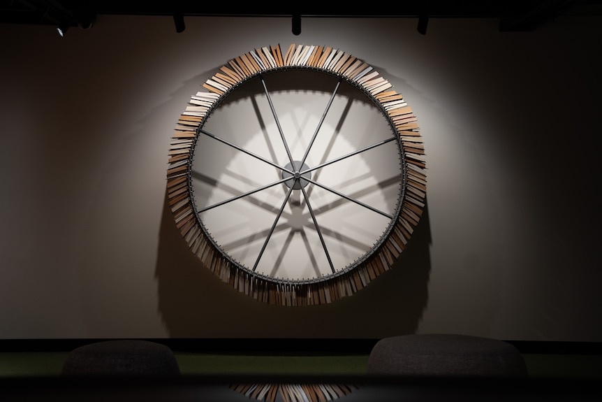 Books spinning around on a wheel, which is erected to a wall.