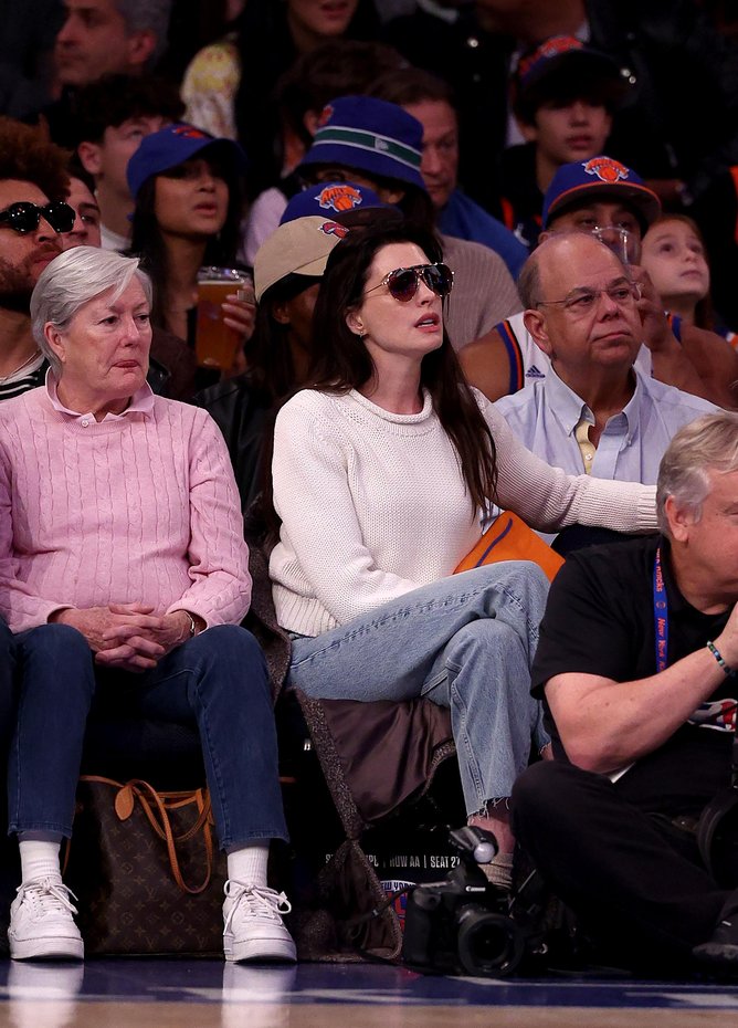 Anne Hathaway attends the game between the New York Knicks and the Charlotte Hornets at Madison Square Garden on November 12, 2023 in New York City. 