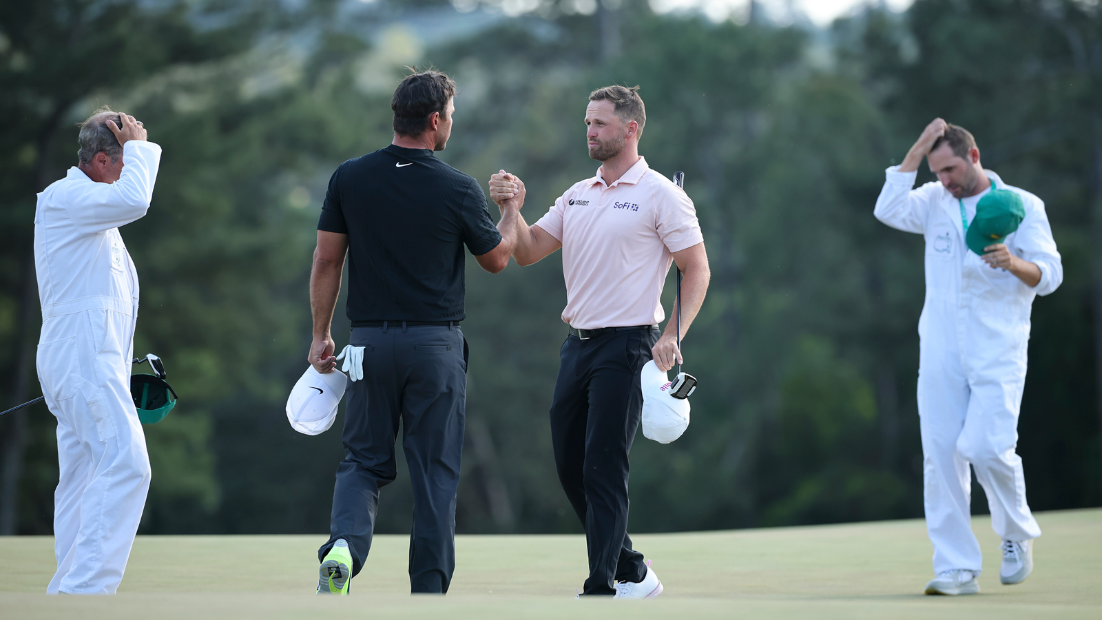 Brooks Koepka and Wyndham Clark shake hands on the 18th hole at The Masters