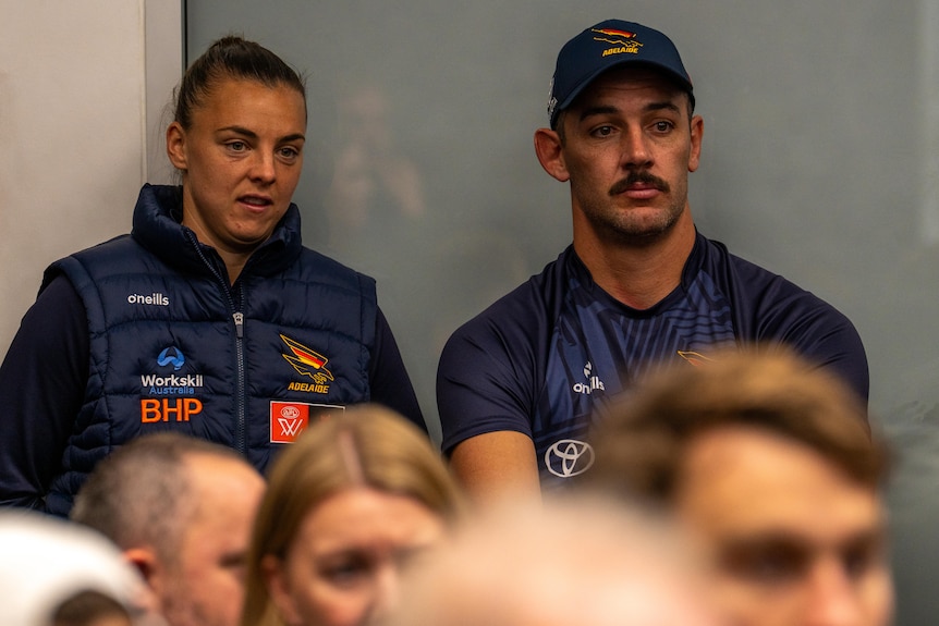 Ebony Marinoff and Taylor Walker in the audience at a media conference.
