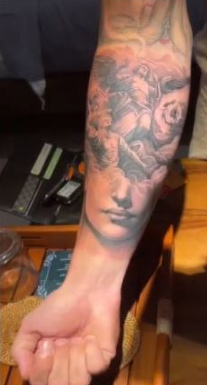 A tattoo on Mr Buzzese’s inner left arm which shows a woman’s face.