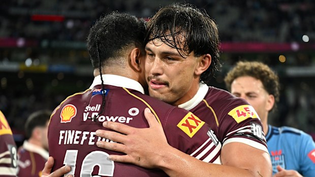 Tino Fa’asuamaleaui embraces Queensland teammate Kulikefu Finefeuiaki after defeating the NSW Blues.
