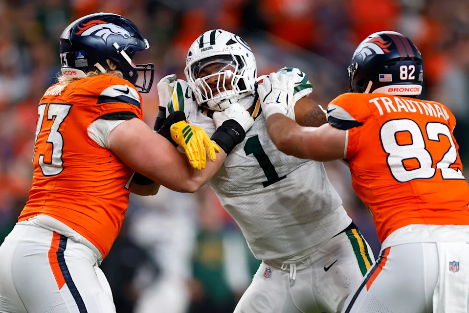 DENVER, COLORADO - DECEMBER 14: Micah Parsons #1 of the Green Bay Packers is double teamed by Frank Crum #73 and Adam Trautman #82 of the Denver Broncos during the third quarter at Empower Field At Mile High on December 14, 2025 in Denver, Colorado. (Photo by Justin Edmonds/Getty Images)