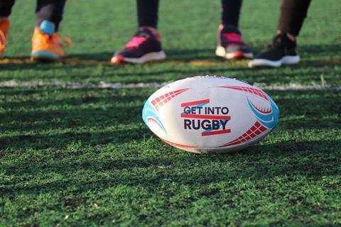 A ball showing World Rugby's Get Into Rugby school-based induction program logo