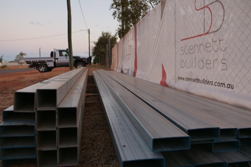 metal beams lay on the ground at a construction site