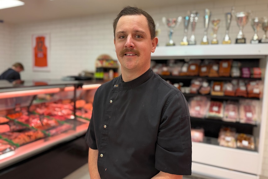 A butcher standing in a butchery.