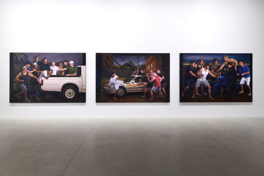 Three large paintings depicting groups of white young men engaging in mob violence.
