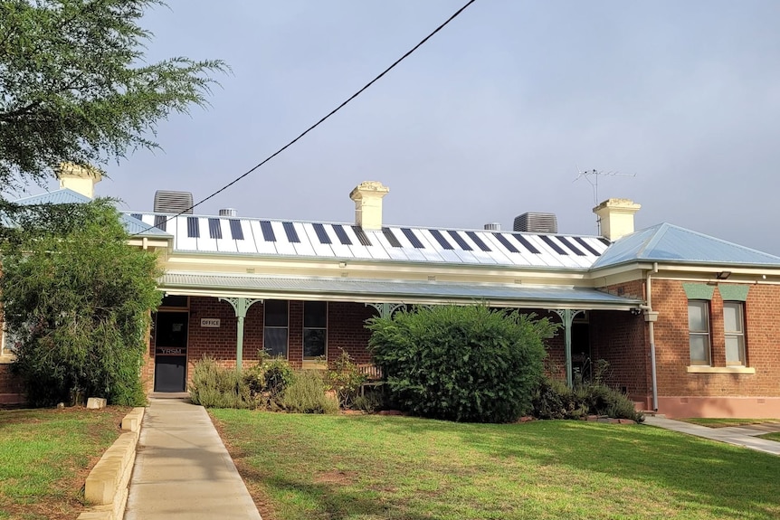 A building with a roof that is painted with stripes to look like the keys of a piano