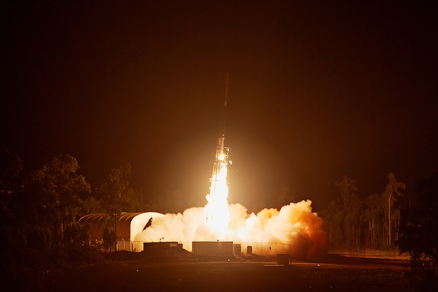 A rocket launching into the air, at night.