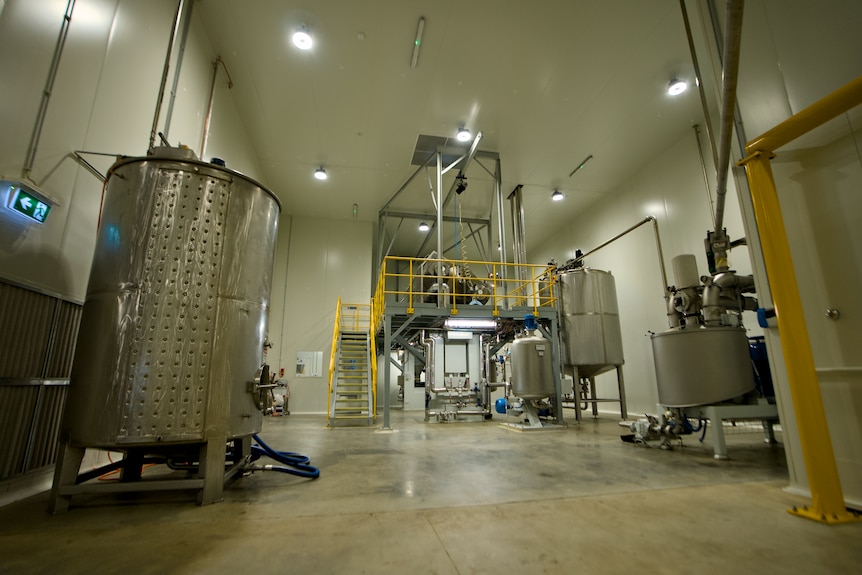 Silver silos inside a factory.