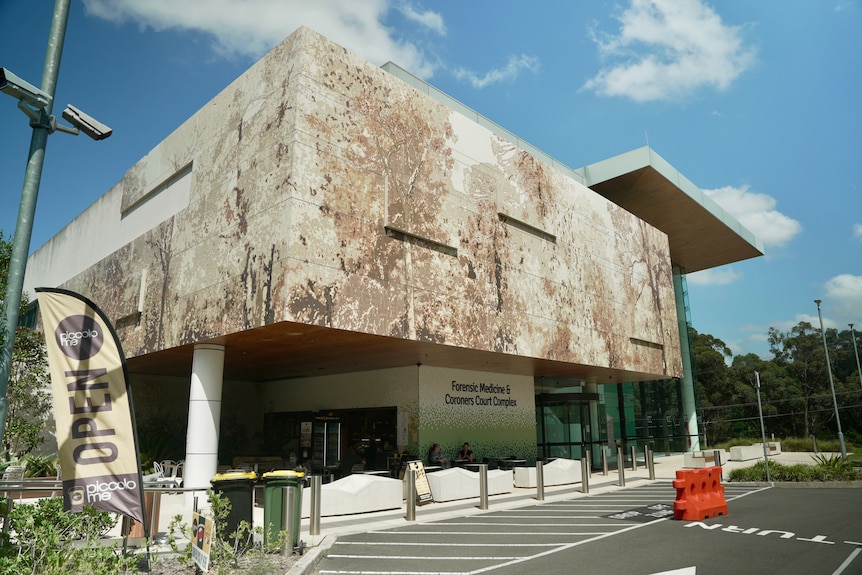 A large building with a brown and white facade.