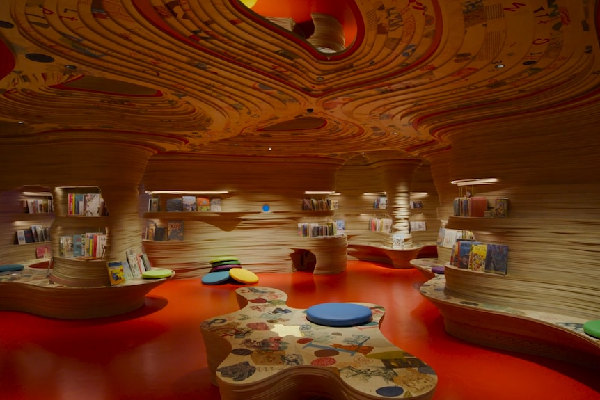 Room with curved seating and roof design.