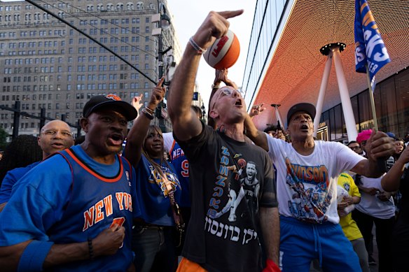Brooklyn Rapper Kosha Dillz (centre) performs with New York Knicks fans outside Madison Square Garden.