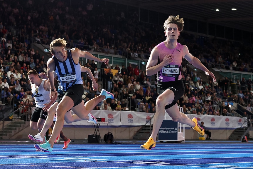 Josh Azzopardi and Rohan Browning cross the finish line in the 100m final at the Australian National Athletics Championships.