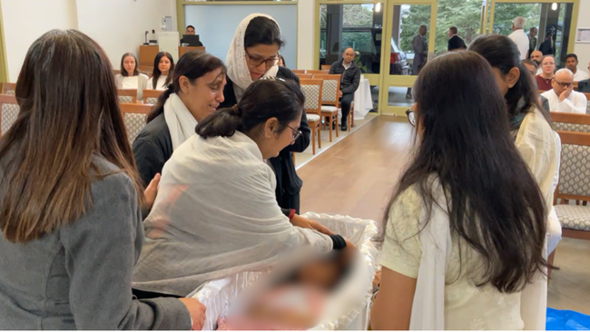  Pritiben Dhandhukia wept beside the coffins. 
