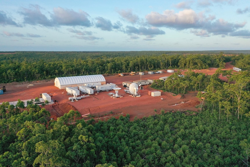 A collection of buildings amid scrub in remote Northern Territory.