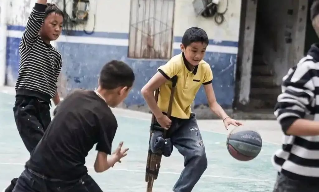 Apei, above, weaves some magic on the basketball court using the crutch his father made. Photo: Handout