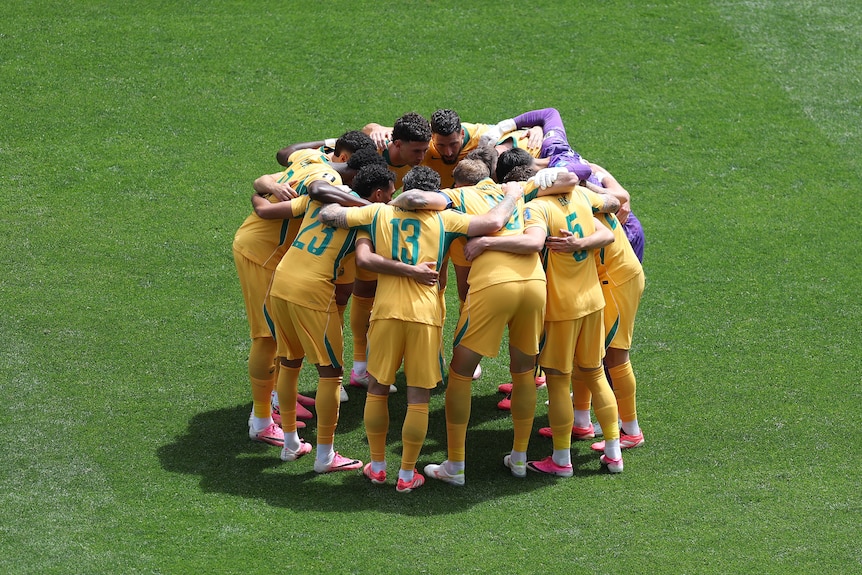 The Socceroos huddle in a circle