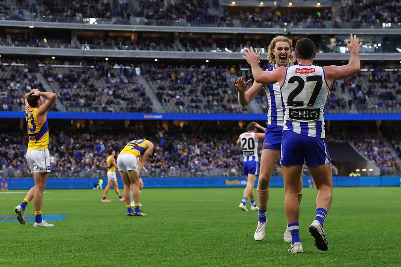Jack Darling and Taylor Goad of the Kangaroos celebrate winning.