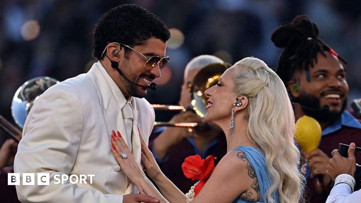Bad Bunny and Lady Gaga smiling at each other as they perform the half-time show at Super Bowl 60