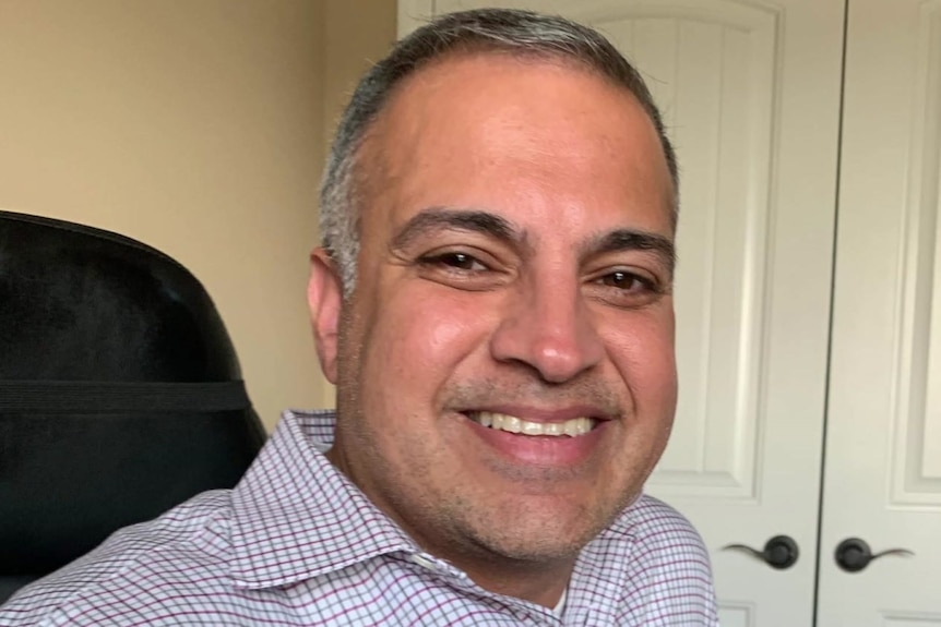 A man, smiling.