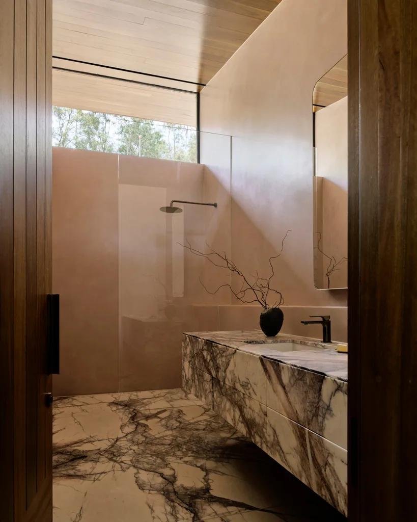 A bathroom swathed in New York marble and rendered walls