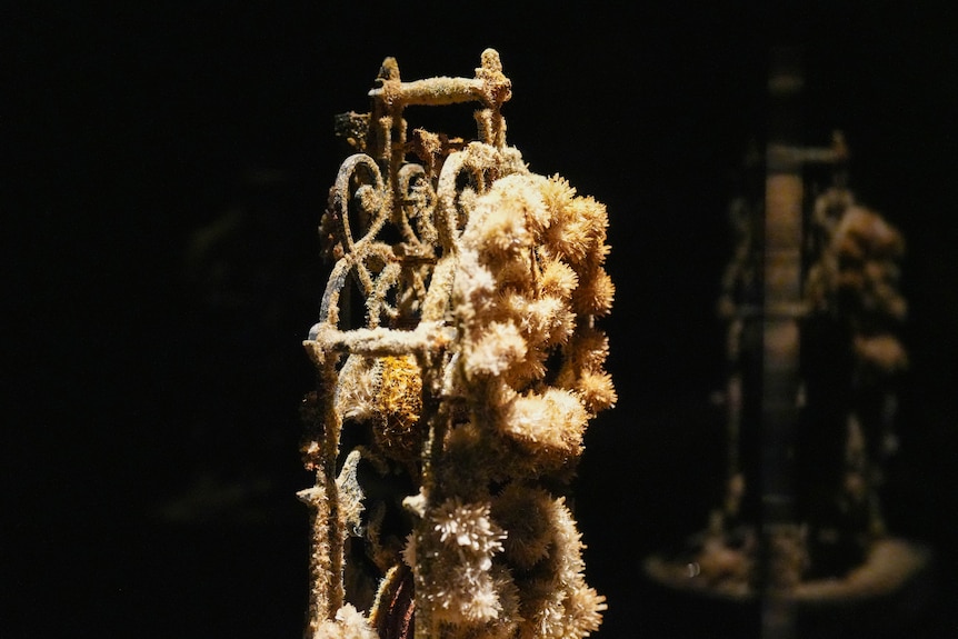 What appears to be crystals coming out of iron ore in an art installation.